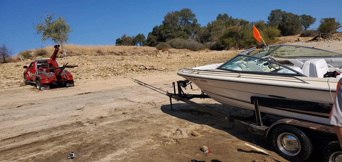Here's our red super star tow truck doing its' magic getting boat and trailer out of serious trouble at Folsom Lake. Sacramento Ace Towing has a tow truck solution for any problem your vehicle experiences. Serving Sacramento, Granite Bay, Roseville, Antelope, Citrus Heights and Rio Linda. One phone call and we will have a truck and a driver on their way to help.